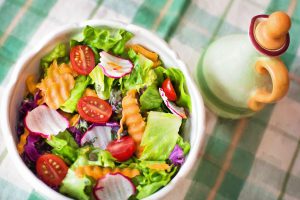 Eating a salad before your meal will help with digestion, and make you feel more full.