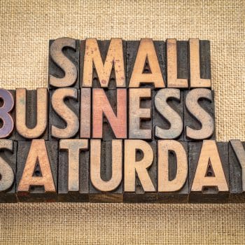 Small Business Saturday word abstract - text in vintage letterpress wood type against burlap canvas, holiday shopping concept