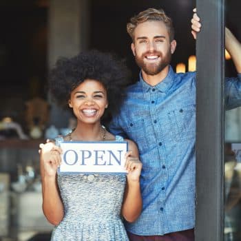 Small Business Insurance Portrait of two proud coffee shop owners holding up a sign on opening dayhttp://195.154.178.81/DATA/i_collage/pi/shoots/806291.jpg