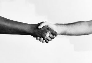 two people shaking hands in friendship
