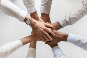 people's hands put together in friendship