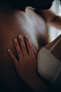 Womans hand on a mans chest