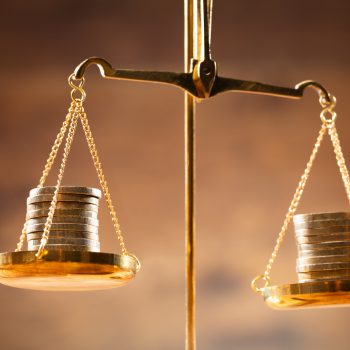 Money on scale, comparison of deductibles and premiums