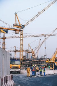 cranes with people working on construction