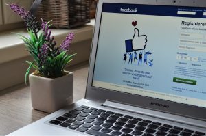 social media on a laptop showing business success