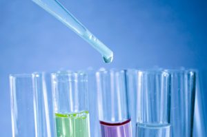 Test tubes with one purple liquid and the other yellow liquid.