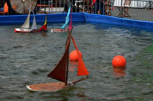Baots in water floating around red balls
