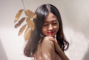 woman dancing happy with lovely skin and a leaf