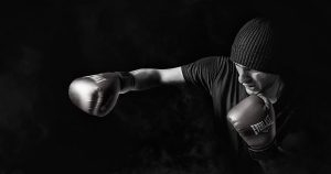 Caucasian man with a beanie on boxing.
