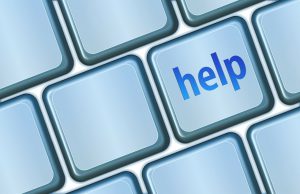 Computer keyboard with a key that says "help" on it.