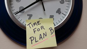 post it note with "time for plan B" on it stuck to a clock.