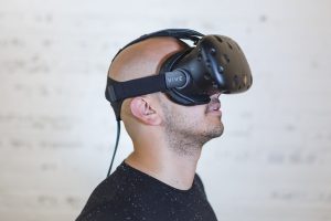 Caucasian man wearing a virtual reality headset.
