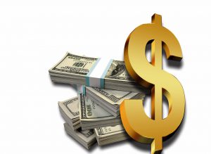 Hundred dollar bills in bands with a gold money sign.