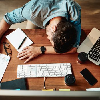 High angle shot of an exhausted young businessman sleeping