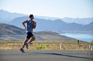 jogger running for men's health down a street