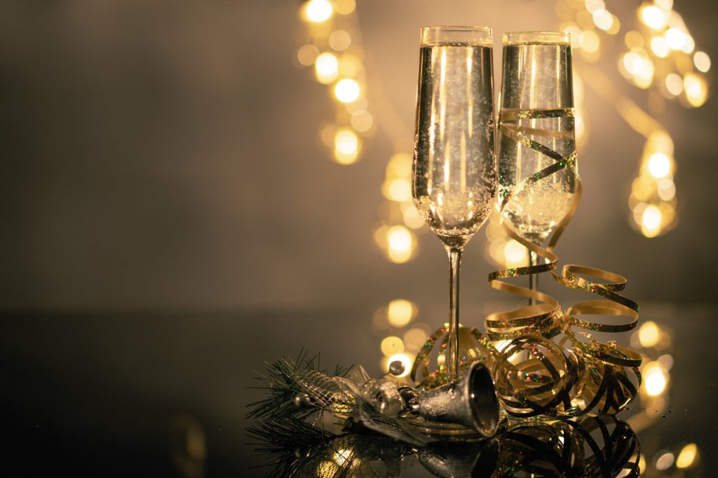 champagne glasses with holiday decor for surviving family stress