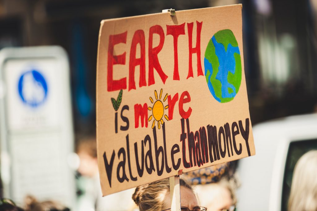 activists raising a sign for climate change
