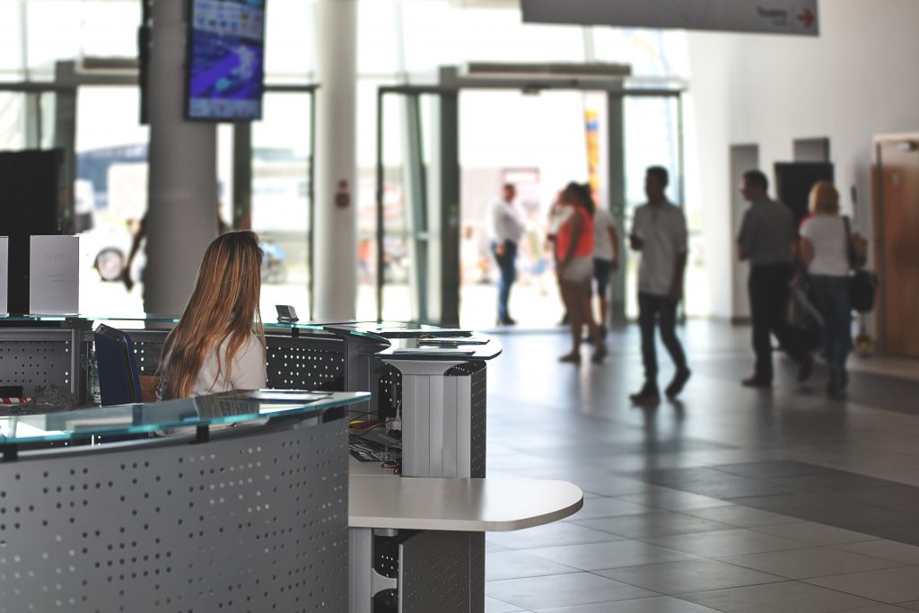 airport terminal filled with people going on a business trip