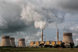 Power plants with a large amount of smoke coming out of it into the air.