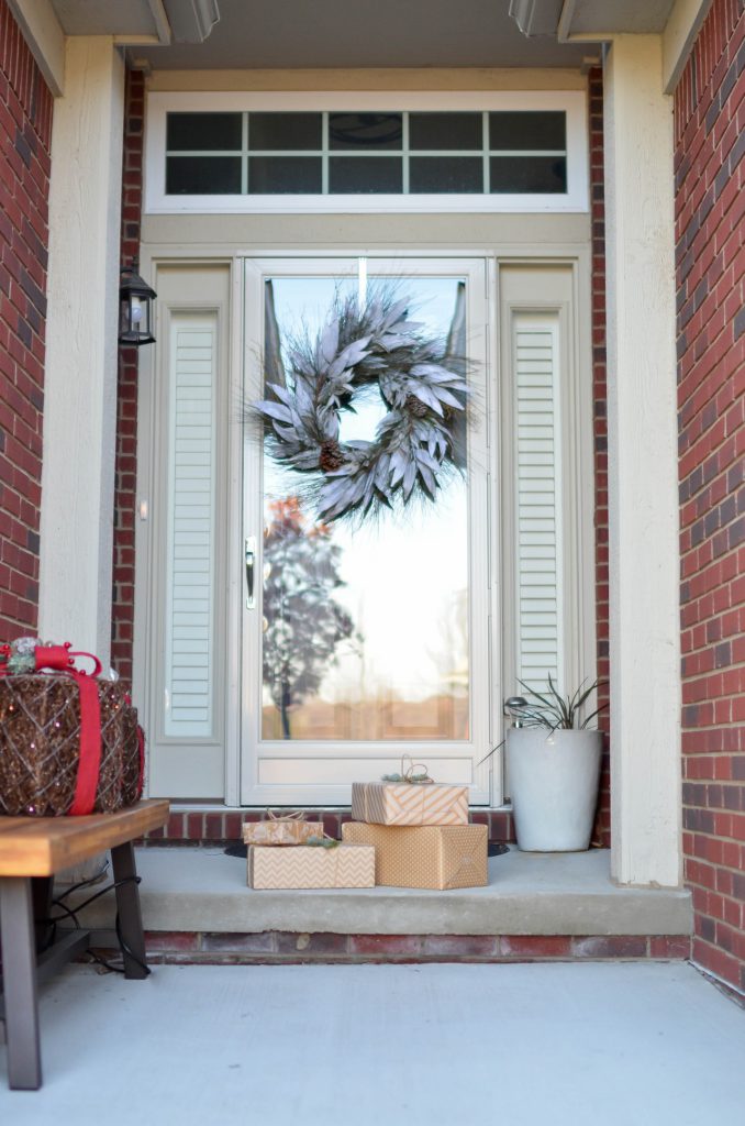 holiday wreath and presents outside a front door