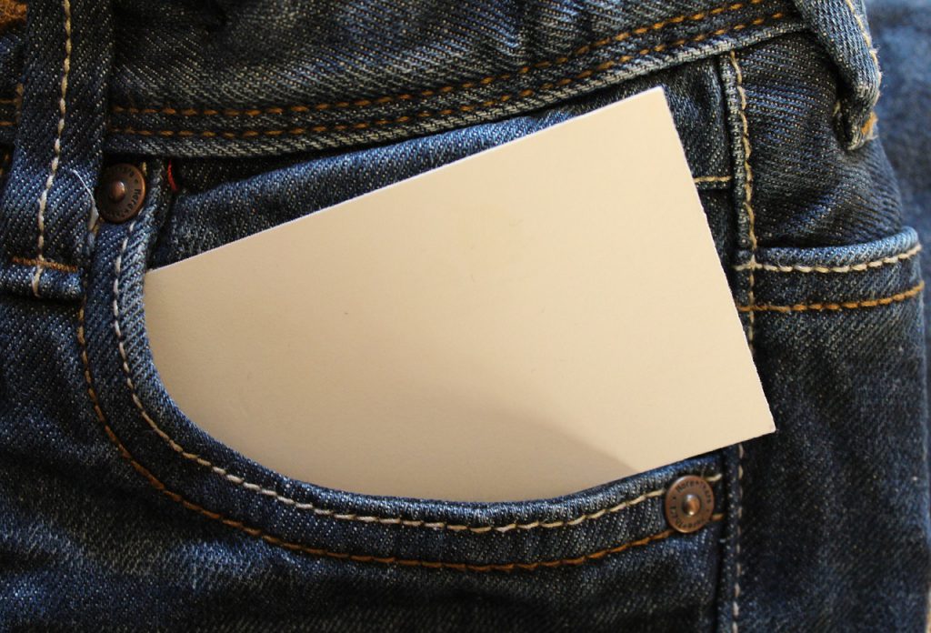 blank piece of paper in a pocket of a pair of jeans.