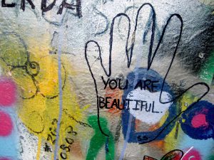 Mural on a wall with the words "you are beautiful" in a hand