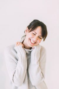 woman smiling in a sweater about menopause solutions