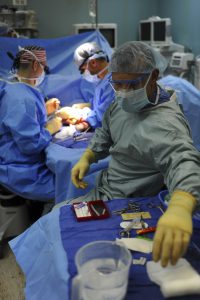 surgeons operating on someone who has worker's compensation to help