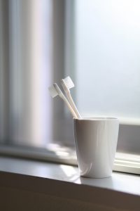 dental care with two toothbrushes in a cup