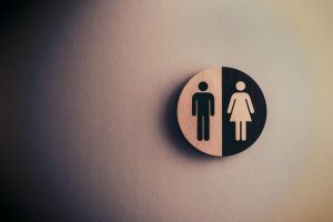 restroom wall sign with male and female