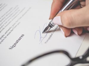 insurance contract with someone signing it