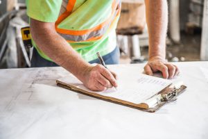 construction foreman with clipboard for risk management