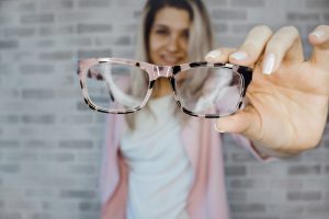 person holding glasses paid for with Medicare