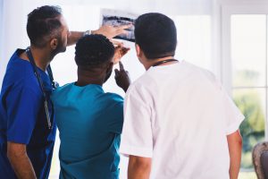 doctors looking at a scan and talking about marketplace rates