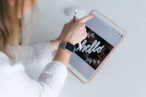 woman with apple ipad desiging a logo for insurance