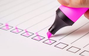 checklist boxes being marked off with a pink highlighter
