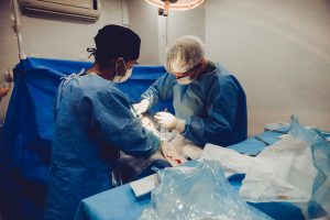 PCP and surgeons operating on a patient