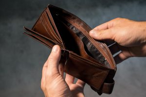 caucasian hands holding open an empty wallet