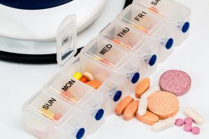 monday-friday pill container with pills inside of it.
