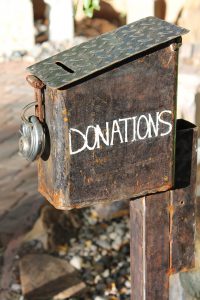 a metal box with a lock on the front that says "donations" on it