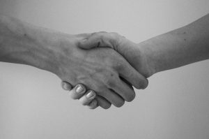black and white picture of two hands shaking