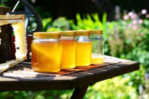 3 full jars of honey and the fourth has a little bit of gold honey in it.