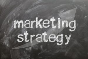 thw words "marketing strategy" pn a blackboard.