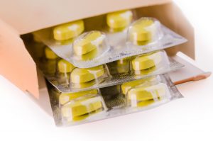 Box filled with pills in cases