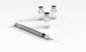 syringe with 3 clear vials.