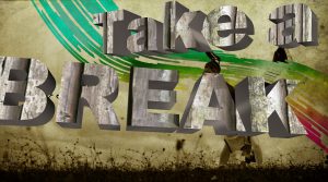 "take a break" grafitti on a wall.