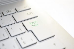 white keyboard with a buttin that says "apply now" on it.