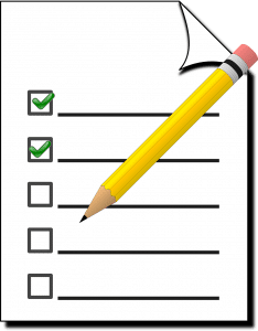 paper with green checkmarks on it and lines with a pencil over it.