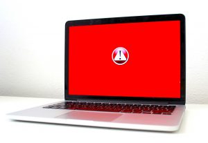 laptop screen that is red with a caution symbol in the middle.