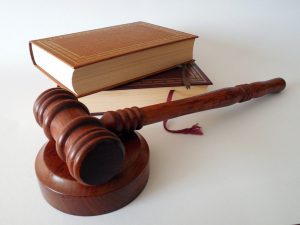 gavel with 2 books stacked on top of each other.
